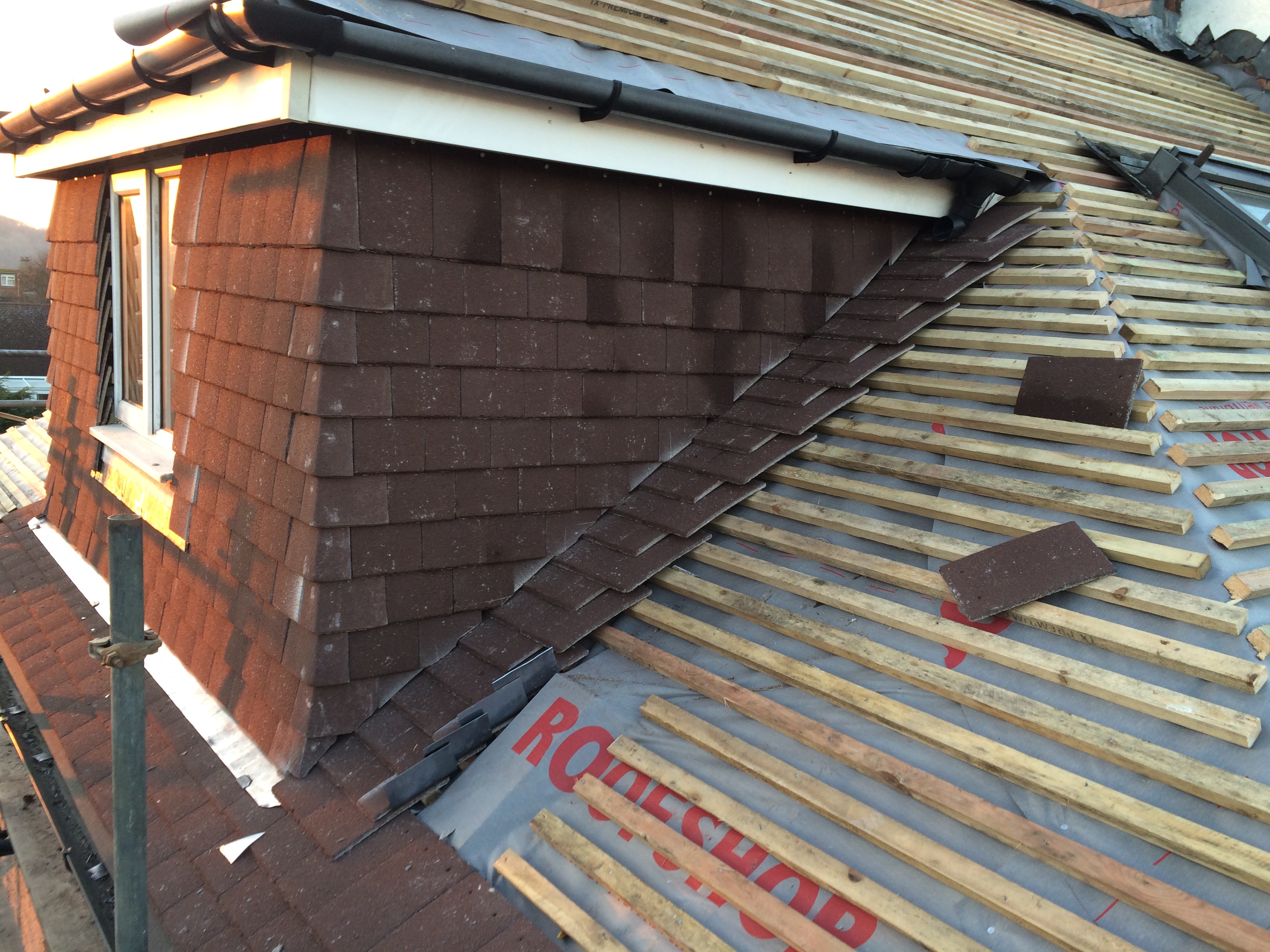 Emergency roof repair team fixing storm damage in Sussex
