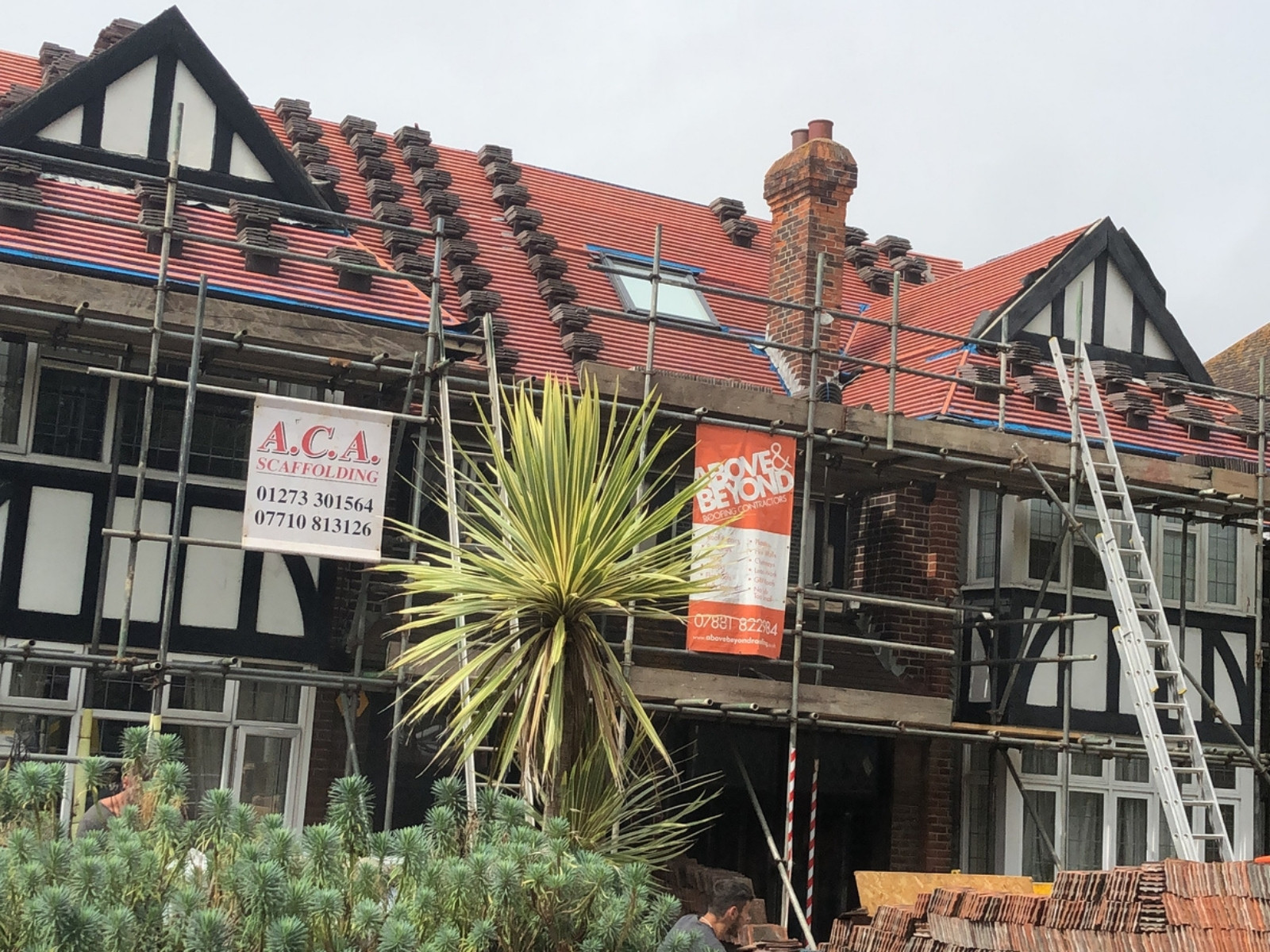 New pitched tiled roof installation in Brighton with scaffolding